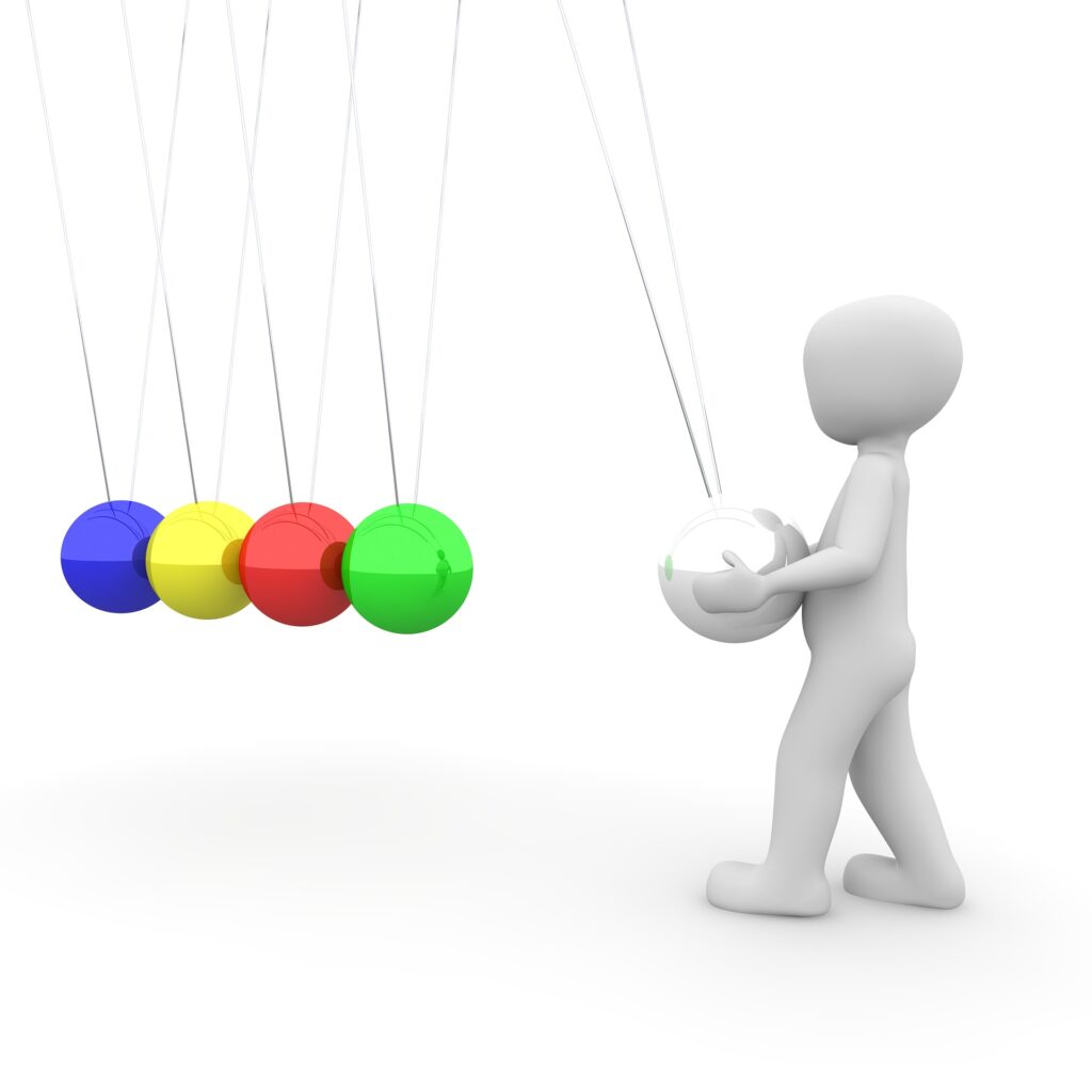 Image of a white clay person holding the silver ball at the end of a string of kinetic balls, ready to release it and make the other balls react representing how you can create compelling scenes with the MRU.
