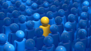 One yellow doll in a bunch of blue ones