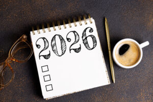 2026 Goals Review shows calendar, pen, coffee, glasses